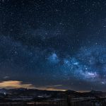 mountains with trees under white star at night